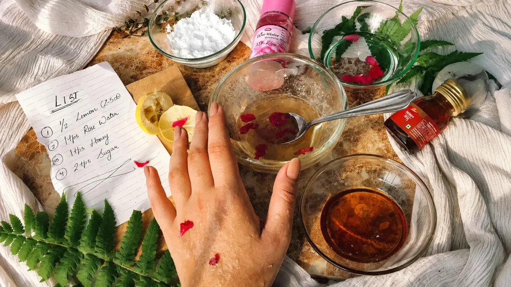 DIY natural hand scrub made with lemon, honey, rose water, and sugar in glass bowls, showing a homemade skincare exfoliation recipe