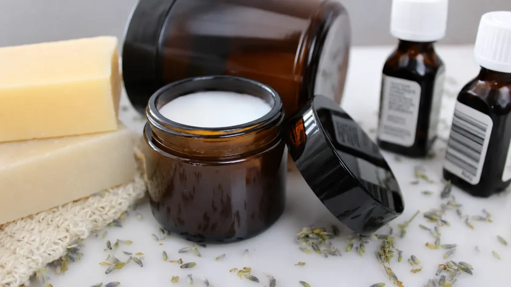 Natural tallow cream in an amber glass jar with lavender and soap bars, showcasing a moisturizing skincare product.